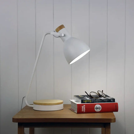 Side view of the Oriel Benny desk lamp featuring a blonde wood base and white shade.