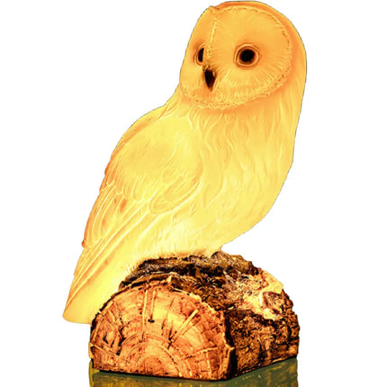 Snowy Owl Table Lamp glowing warmly in a dimly lit room