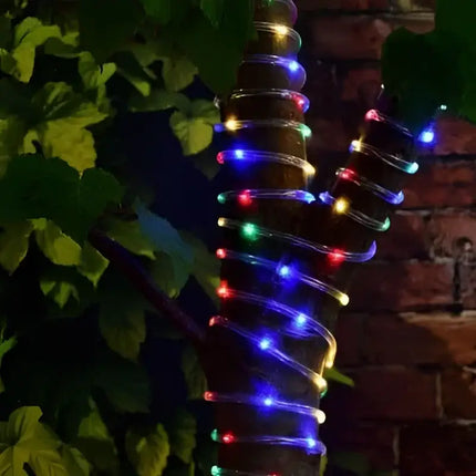 Tree trunk wrapped in colorful string lights for Solar 10 Metre Ropelight Multicolor display