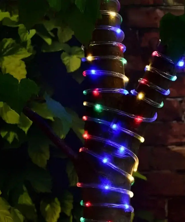 Tree trunk wrapped in colorful string lights for Solar 10 Metre Ropelight Multicolor display