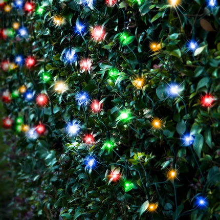 Colorful string lights on a leafy bush for Solar 150 LED Net Light in Red White Green