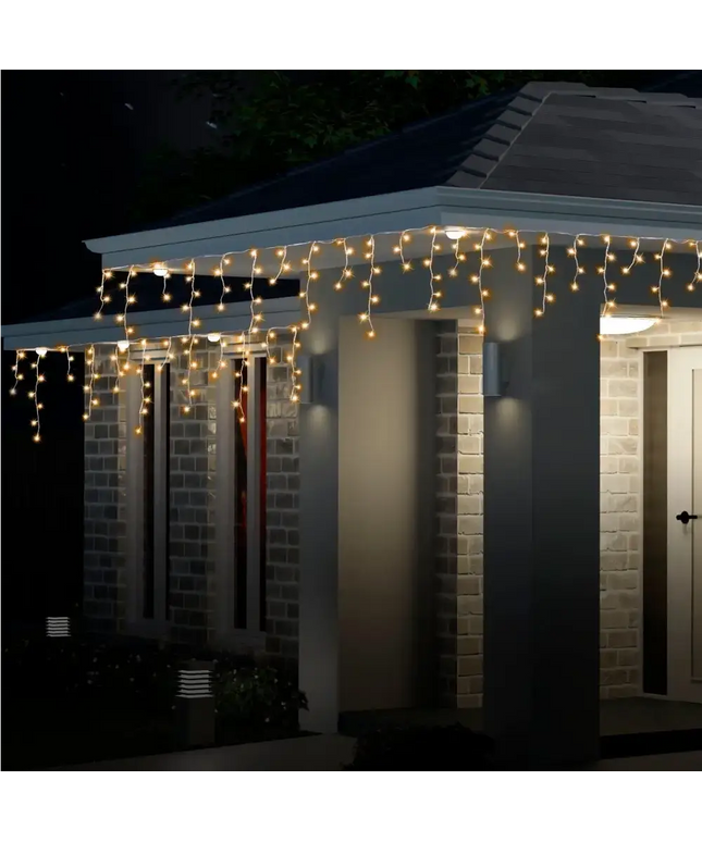Illuminated icicle lights on house for festive decoration Solar 200 LED Cool White