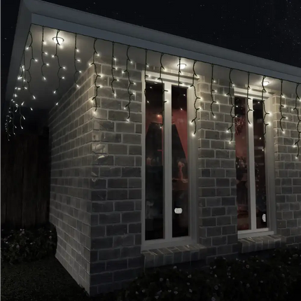 Brick building decorated with warm white solar LED icicle lights for festive ambiance