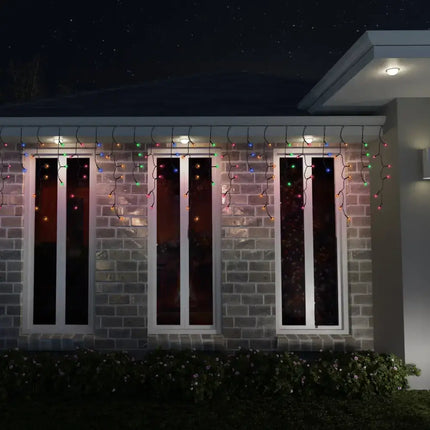 Brick house decorated with warm white Christmas lights from Solar 200 LED Icicle Lights