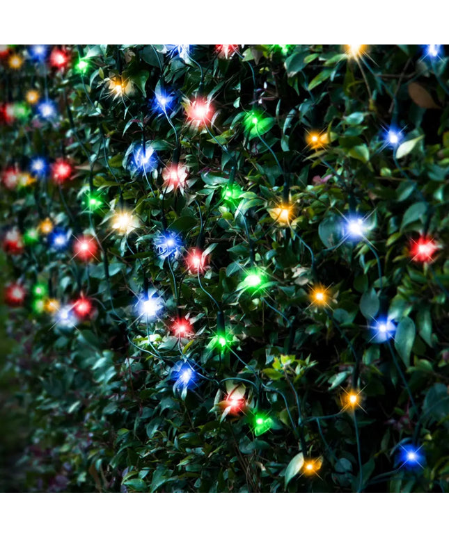 Colorful string lights on leafy bush showcasing Solar 250 LED Net Light in warm white