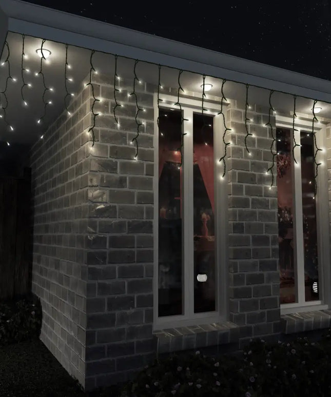 Brick building decorated with colorful Solar 400 LED Icicle Lights and icicle lighting