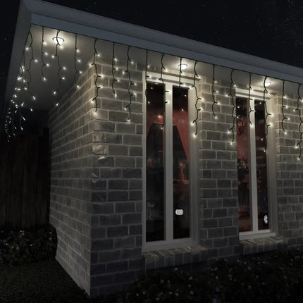 Brick building decorated with multicolor solar LED icicle lights for festive illumination