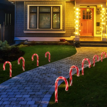 Solar Candy Cane Path Lights in an 8-pack illuminating the walkway with festive charm