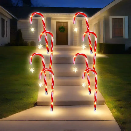 Illuminated candy cane pathway lights with star accents from Solar Candy Canes with Stars 4 Pack