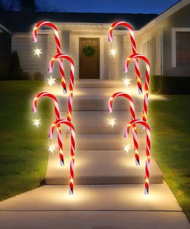Illuminated candy cane pathway lights with star accents from Solar Candy Canes with Stars 4 Pack