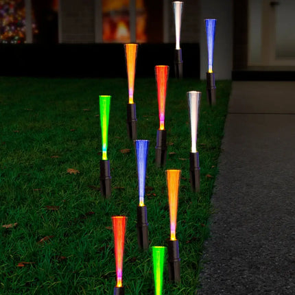 Colorful fiber optic solar pathway lights illuminating a garden path