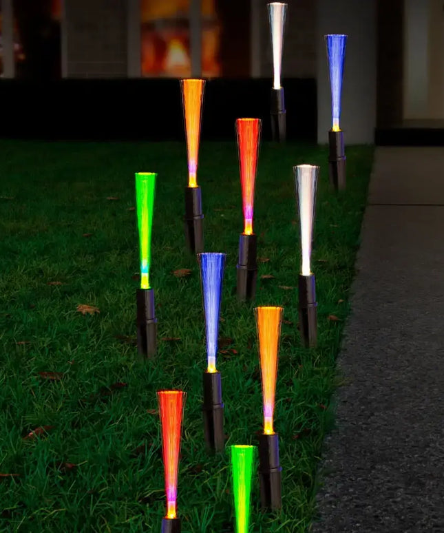 Colorful fiber optic solar pathway lights illuminating a garden path